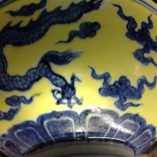 A Chinese yellow ground dragon and phoenix bowl, Xuande six character mark and possibly of the period, 19.5cm, museum restoration, sc